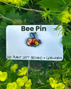 The bee pin on its backing card