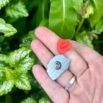 The back of a pin and its heart-shaped clasp